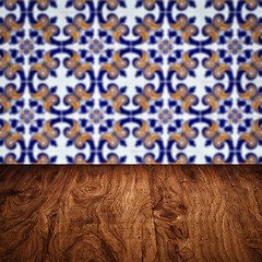 Image showing Wood table top and blur vintage ceramic tile pattern wall