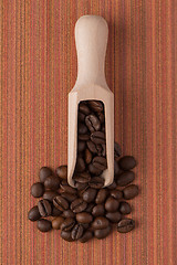 Image showing Wooden scoop with coffee beans