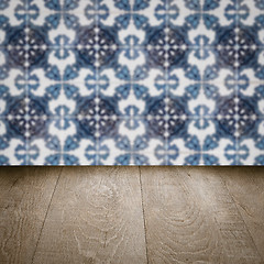 Image showing Wood table top and blur vintage ceramic tile pattern wall