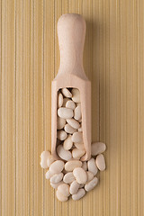 Image showing Wooden scoop with white beans