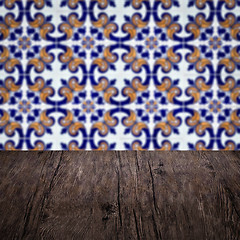 Image showing Wood table top and blur vintage ceramic tile pattern wall