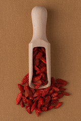 Image showing Wooden scoop with dry red goji berries