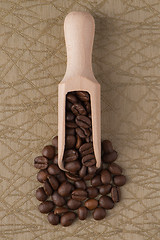 Image showing Wooden scoop with coffee beans