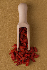 Image showing Wooden scoop with dry red goji berries