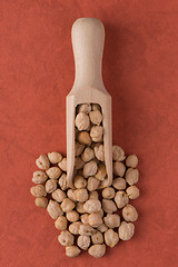 Image showing Wooden scoop with chickpeas