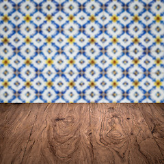 Image showing Wood table top and blur vintage ceramic tile pattern wall