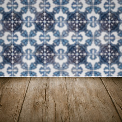 Image showing Wood table top and blur vintage ceramic tile pattern wall