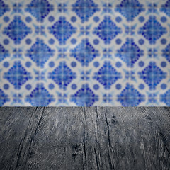 Image showing Wood table top and blur vintage ceramic tile pattern wall