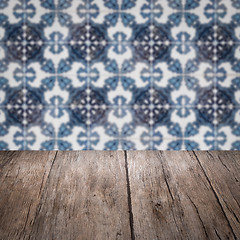 Image showing Wood table top and blur vintage ceramic tile pattern wall