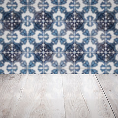 Image showing Wood table top and blur vintage ceramic tile pattern wall