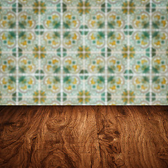 Image showing Wood table top and blur vintage ceramic tile pattern wall