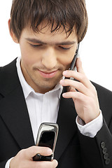 Image showing businessman with two cellular phones