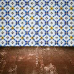 Image showing Wood table top and blur vintage ceramic tile pattern wall