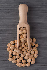 Image showing Wooden scoop with chickpeas