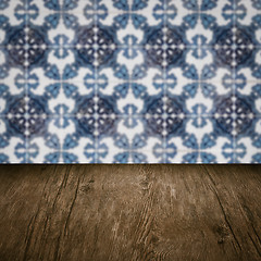 Image showing Wood table top and blur vintage ceramic tile pattern wall