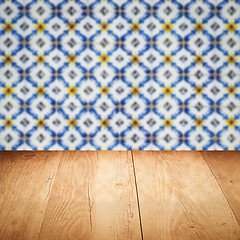 Image showing Wood table top and blur vintage ceramic tile pattern wall