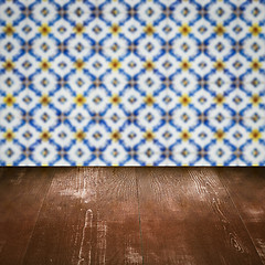 Image showing Wood table top and blur vintage ceramic tile pattern wall