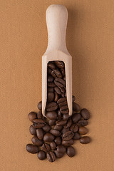 Image showing Wooden scoop with coffee beans