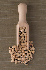 Image showing Wooden scoop with white beans