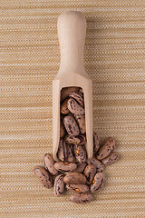 Image showing Wooden scoop with pinto beans