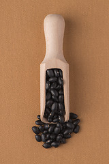 Image showing Wooden scoop with black beans