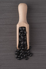 Image showing Wooden scoop with black beans