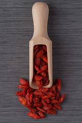 Image showing Wooden scoop with dry red goji berries