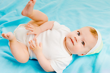 Image showing baby lying on a blue plaid