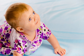 Image showing Crawling across the blue plaid baby looking up