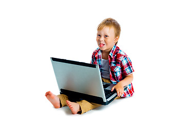 Image showing little boy with a laptop sitting on the floor