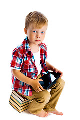 Image showing boy with a Tablet PC sitting on the books