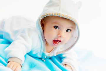 Image showing beautiful baby lying on a blue plaid