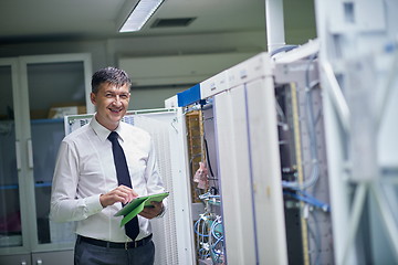 Image showing network engineer working in  server room