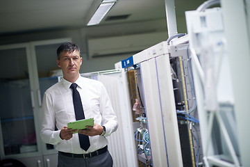 Image showing network engineer working in  server room