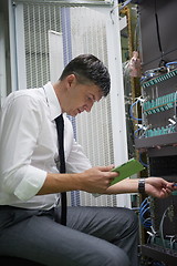 Image showing network engineer working in  server room