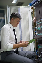 Image showing network engineer working in  server room