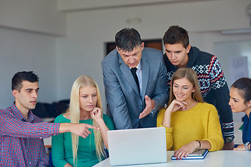 Image showing group of students getting suppport from teacher