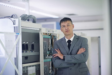 Image showing network engineer working in  server room