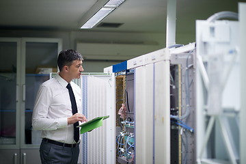 Image showing network engineer working in  server room