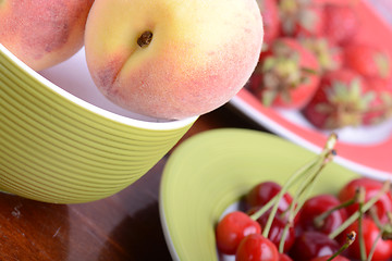 Image showing fresh fruits and berries mixed collection surface close up, summer health food, peach, cherry, strawberry.