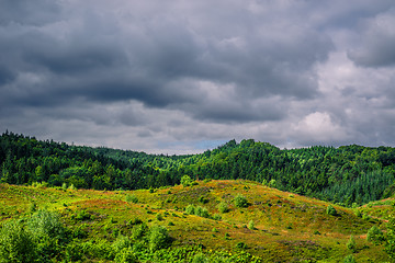 Image showing Dark clouds hanging over green nature