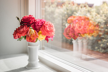 Image showing Pink roses in a window