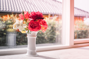 Image showing Bouquet of roses in a window