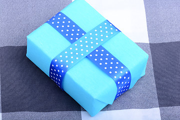 Image showing blue gift box with white ribbon