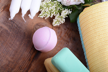 Image showing towels set, aroma therapy, soap and sea salt on wooden plate 