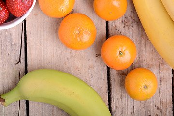 Image showing Fresh colorful fruits composition mandarin, bananas and orange