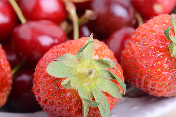 Image showing Sweet cherries and strawberries close up