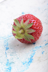 Image showing big fresh strawberry with green leave, close up