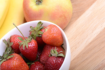 Image showing Close-up shot of variety of fruits on old wooden plate