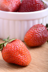 Image showing close up of big strawberry on wood